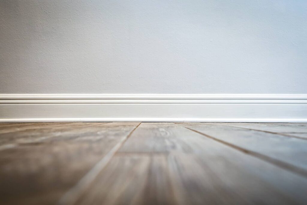 Quarter-round can help fill gaps between your baseboard and tile floor.