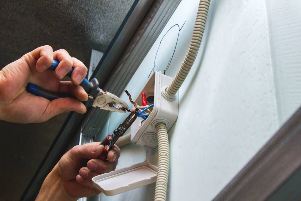 Electrician helps with appliance wiring.