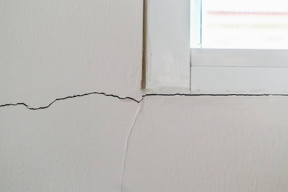 A horizontal foundation crack stretching all the way across a window sill.