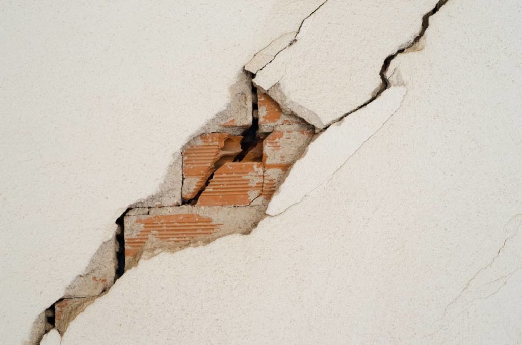 Major stucco and block filling are needed to repair this crack.