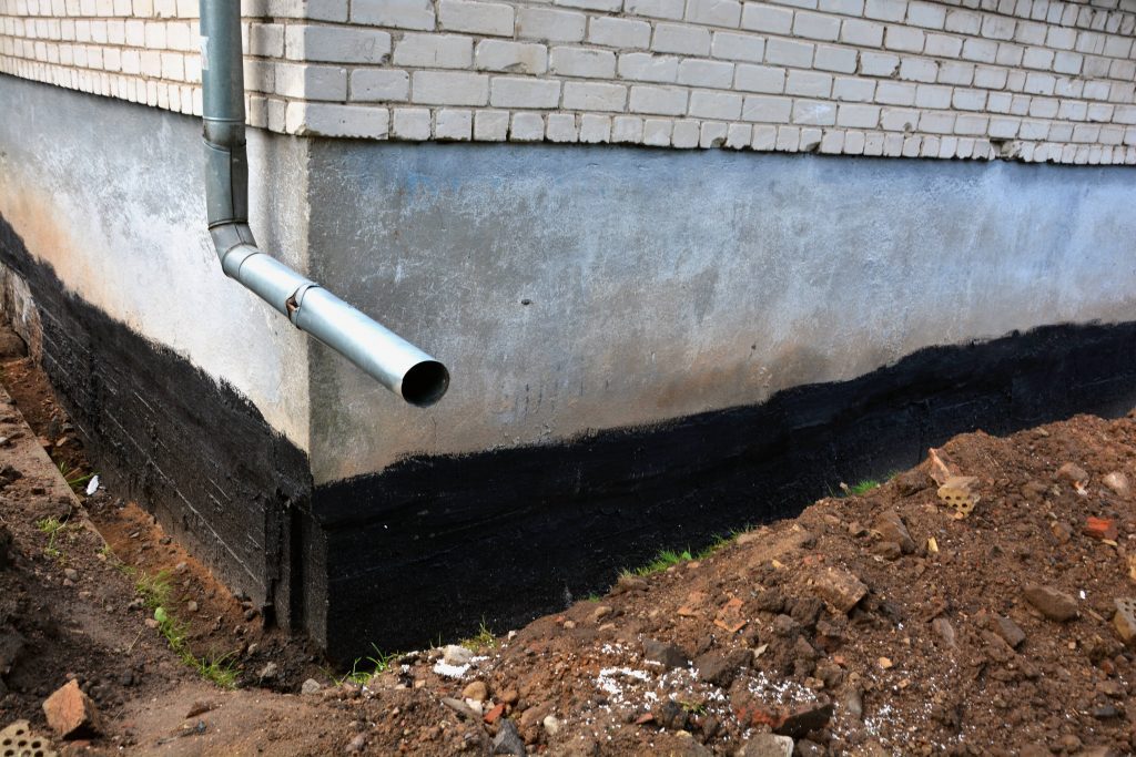 Rubber cement can seal foundation base on a house