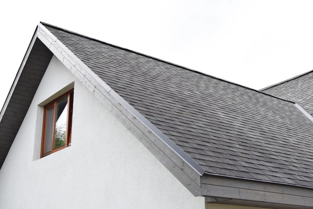 Wood eaves support the slope of this asphalt shingled roof.